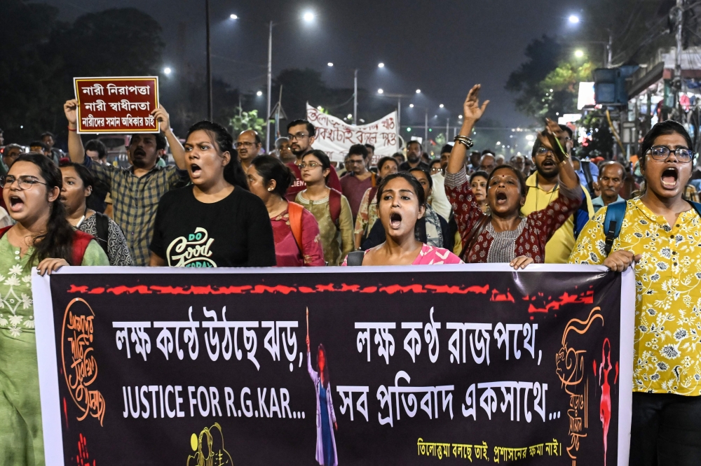 Activists and medical professionals shout slogans during a protest march to condemn the rape and murder of a doctor in Kolkata on October 1, 2024. — AFP