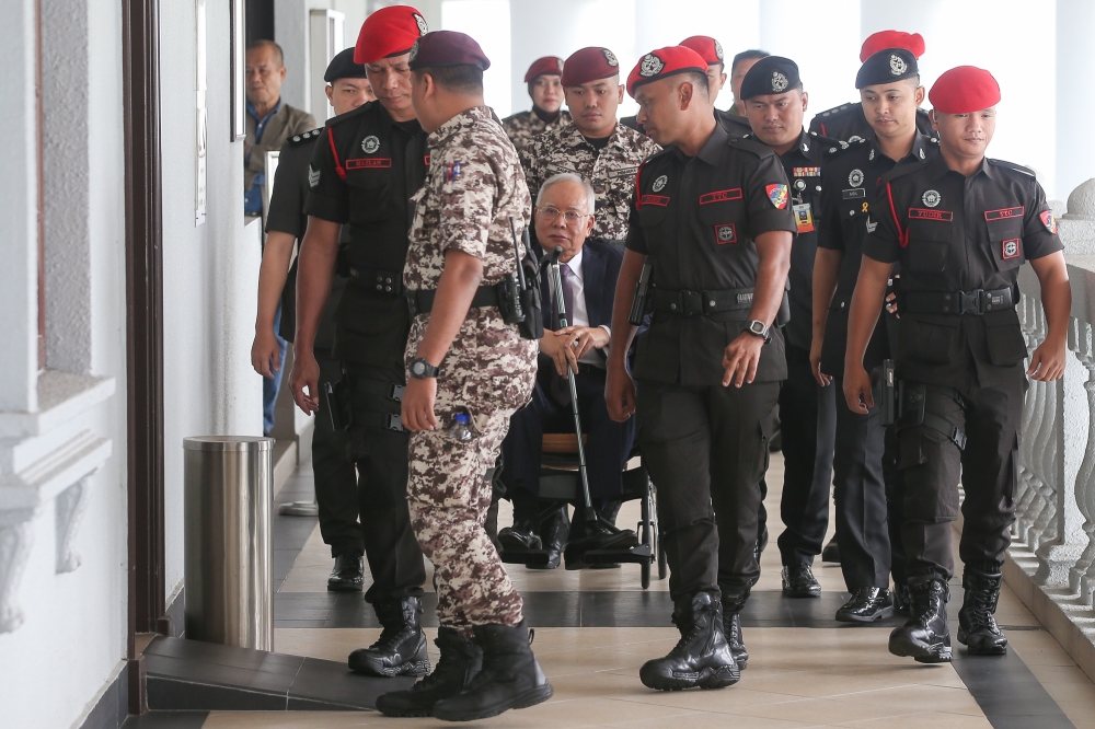 Datuk Seri Najib Razak is pictured in a wheelchair at the Kuala Lumpur High Court Complex on October 3, 2024. — Picture by Yusof Mat Isa