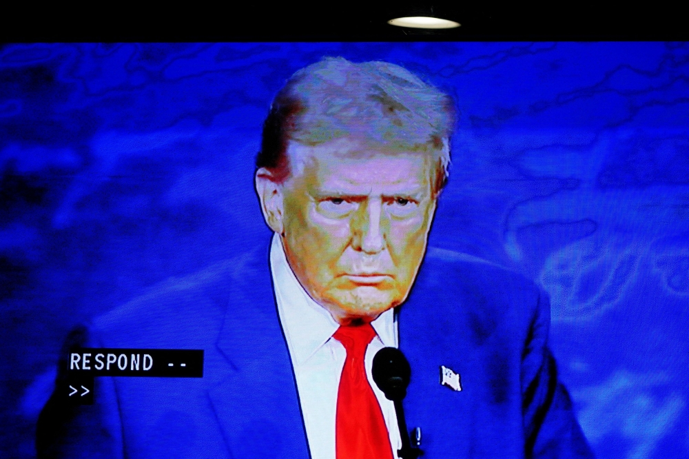 A screen shows Republican presidential nominee and former U.S. President Donald Trump during a presidential debate between Trump and Democratic presidential nominee and US Vice President Kamala Harris at a watch party hosted by the New York Young Republican Club, in New York City on September 10. — Reuters pic