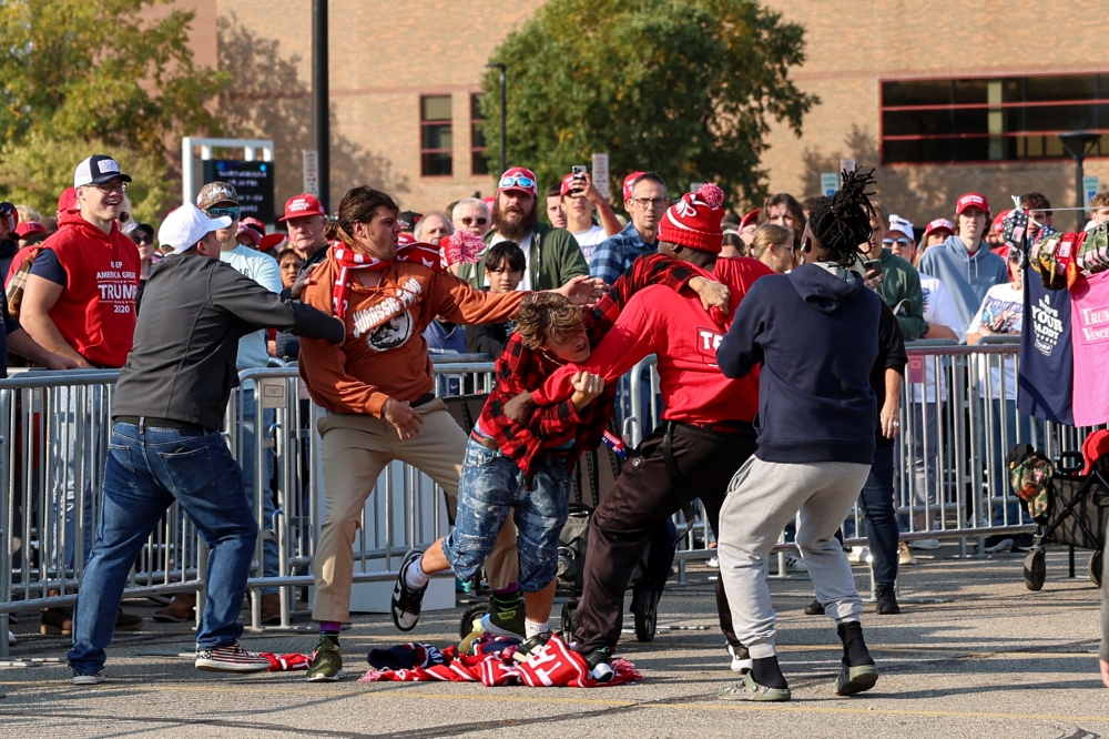 Vendors fight outside a rally for Republican presidential nominee and former U.S. President Donald Trump in Saginaw, Michigan, U.S., October 3, 2024. — Reuters pic
