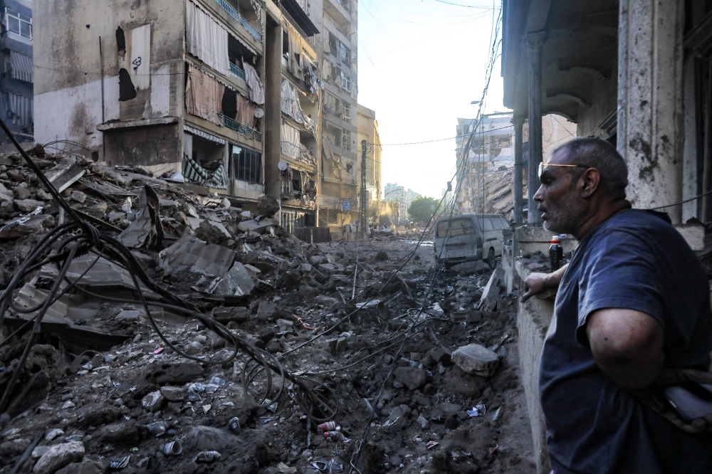 A resident stares at the destruction in the aftermath of an Israeli strike on the neighbourhood of Mreijeh in Beirut's southern suburbs on October 4, 2024. — AFP pic