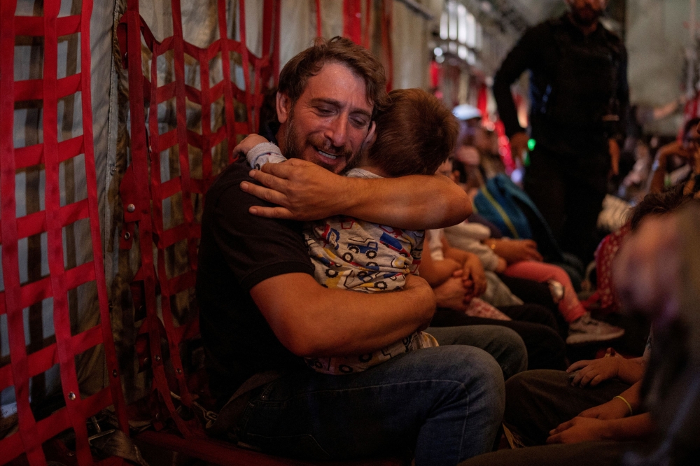 A father hugs his son, as Greek and Greek Cypriot nationals are evacuated from Lebanon on a Hellenic Air Force C130, due to ongoing hostilities between Hezbollah and the Israeli forces, in Beirut October 3, 2024. — Reuters pic  
