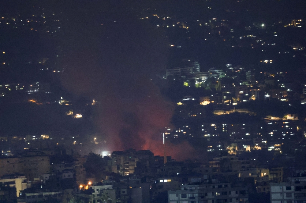 Smoke billows over Beirut's southern suburbs after a strike, amid ongoing hostilities between Hezbollah and Israeli forces, as seen from Sin El Fil, Lebanon, October 5, 2024. — Reuters pic