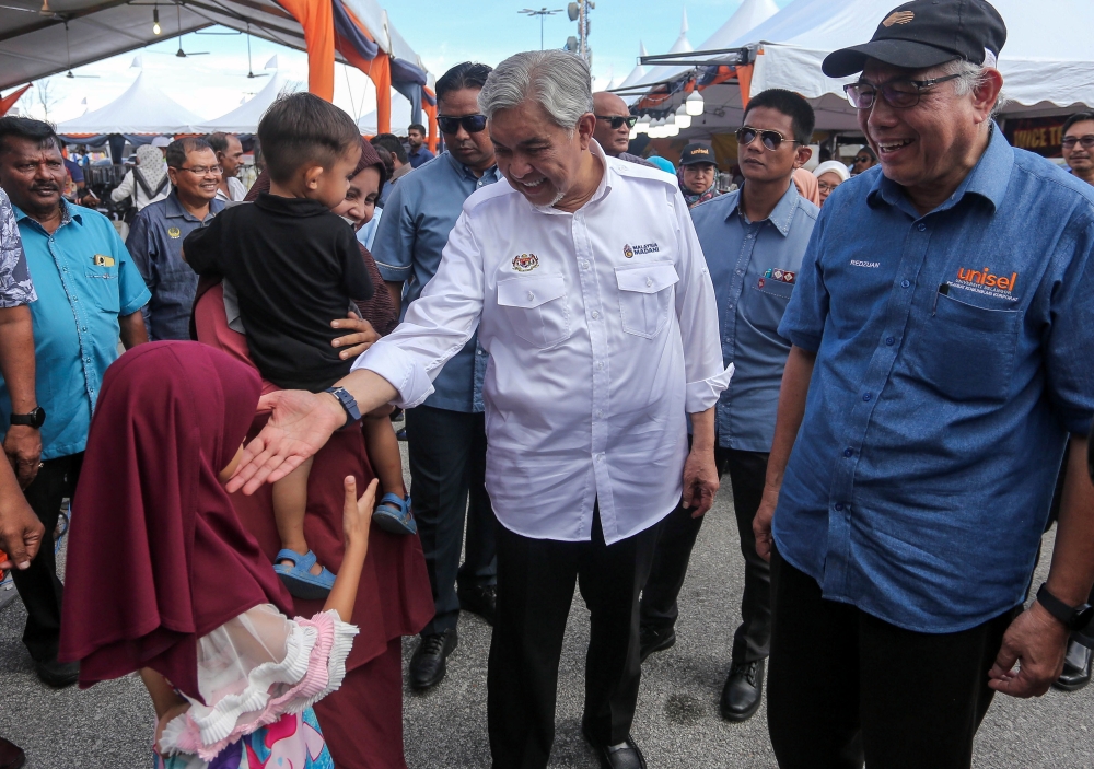 Datuk Seri Ahmad Zahid Hamidi (in white shirt) greets Bagan Datuk constituents during a celebration in the Perak state seat of which he is the elected representative on October 6, 2024. — Bernama pic