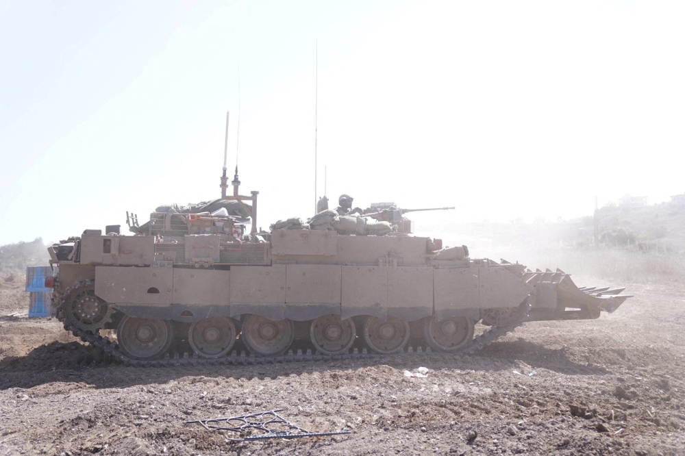 An Israeli armoured vehicle operates at a location given as Southern Lebanon in this image released on October 6, 2024. — Israel Defence Forces handout via Reuters