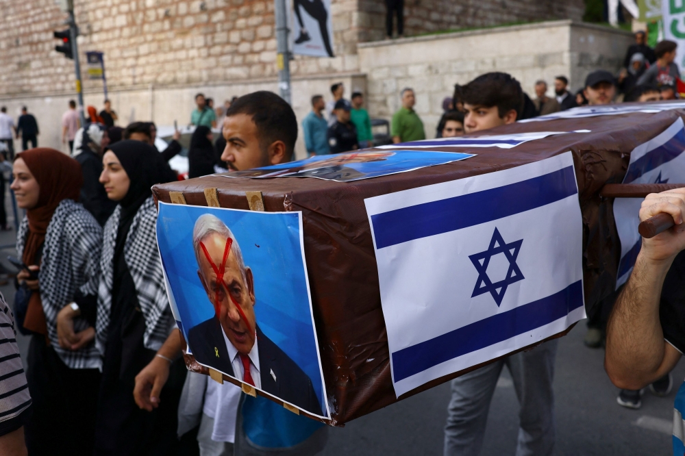 Demonstrators carry a mock coffin with the pictures of Israel's Prime Minister Benjamin Netanyahu during a protest to express support for Palestinians in Gaza, a day ahead of the anniversary of the October 7th attack, amid the Israel-Hamas conflict, in Istanbul, Turkey, October 6, 2024. — Reuters pic