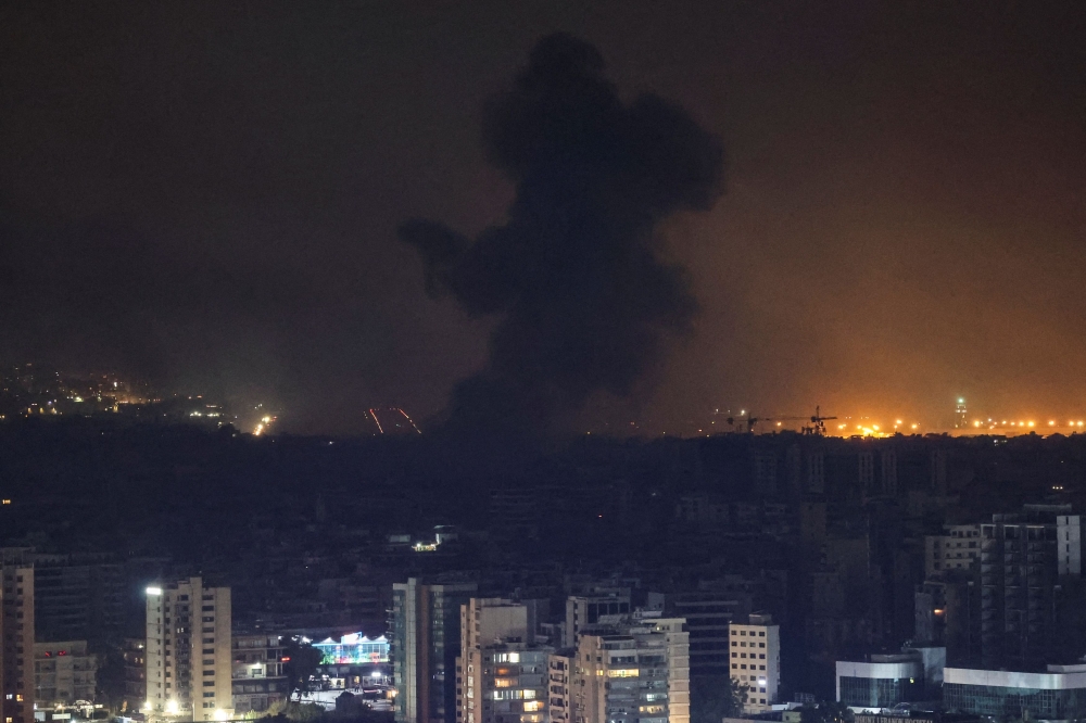 Smoke billows over Beirut southern suburbs after a strike, amid the ongoing hostilities between Hezbollah and Israeli forces, as seen from Sin El Fil, Lebanon October 7, 2024.  — Reuters pic