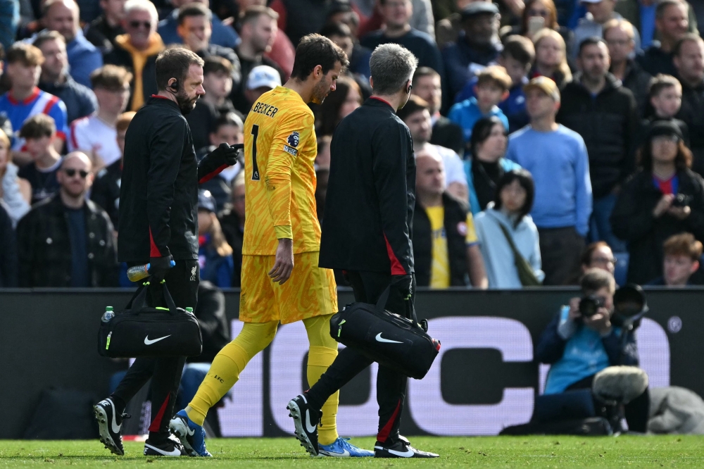 Liverpool's goalkeeper Alisson Becker leaves the game after picking up an injury during the English Premier League football match between Crystal Palace and Liverpool at Selhurst Park in south London on October 5, 2024. — AFP pic