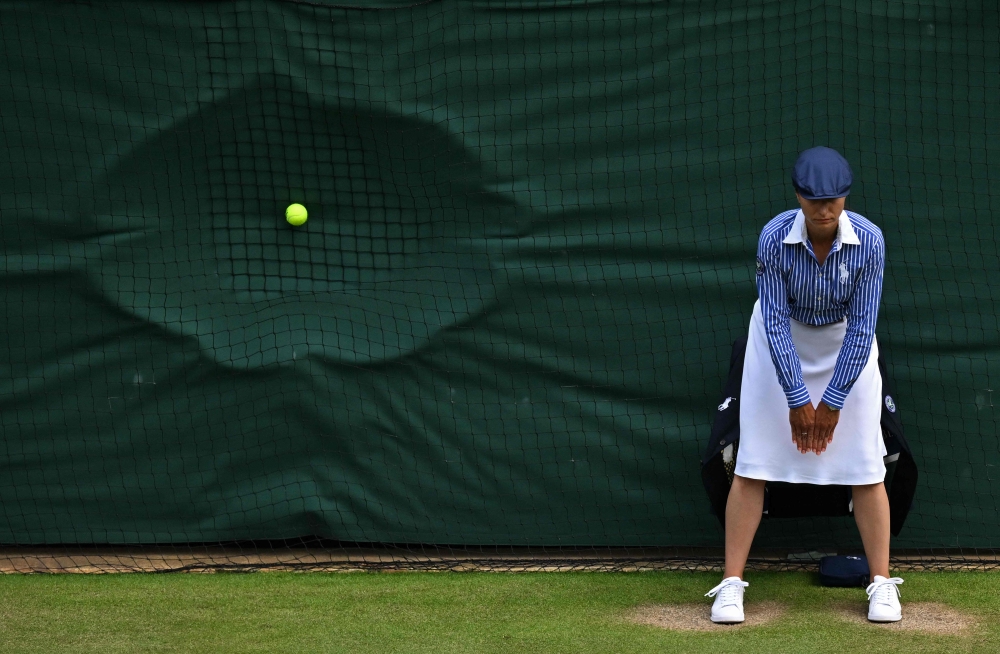 Wimbledon announced on October 9, 2024, that it is scrapping its iconic line judges in favour of electronic line-calling, changing the face of the grass-court tournament. — AFP pic