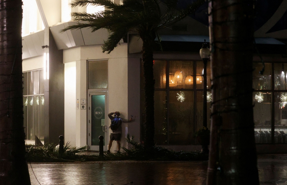 A man records the storm as Hurricane Milton makes landfall, in Sarasota, Florida October 9, 2024. — Reuters pic