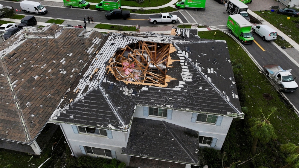 A drone view shows a house with its roof damaged by a tornado in a zone affected by Hurricane Milton, in Palm Beach Gardens, Florida. — Reuters pic
