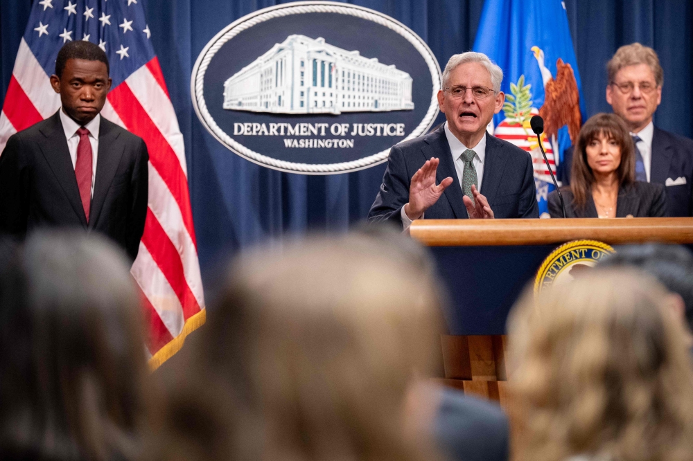 US Attorney General Merrick Garland (2nd-L) announces TD Bank's guilty plea and $3 billion in fines during a news conference yesterday. — AFP pic