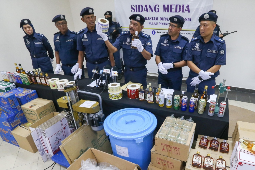 State Customs Department director Datuk Roselan Ramli shows the items seized in both raids. — Picture by Opalyn Mok