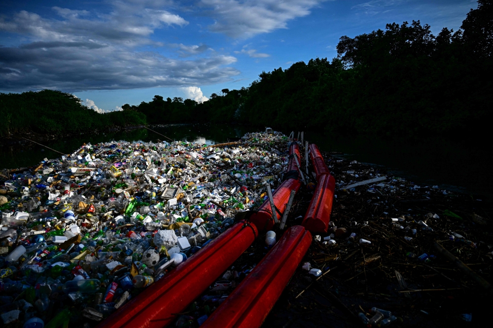 A gigantic hydraulic and solar-powered machine called 'Wanda' collects plastic waste accumulated at the Juan Diaz River in Panama City on October 1, 2024. In two years, a gigantic hydraulic machine in a river in Panama City has prevented 256 tonnes of rubbish, mainly plastic bottles, from ending up in the mangroves of the Panamanian capital. — AFP pic