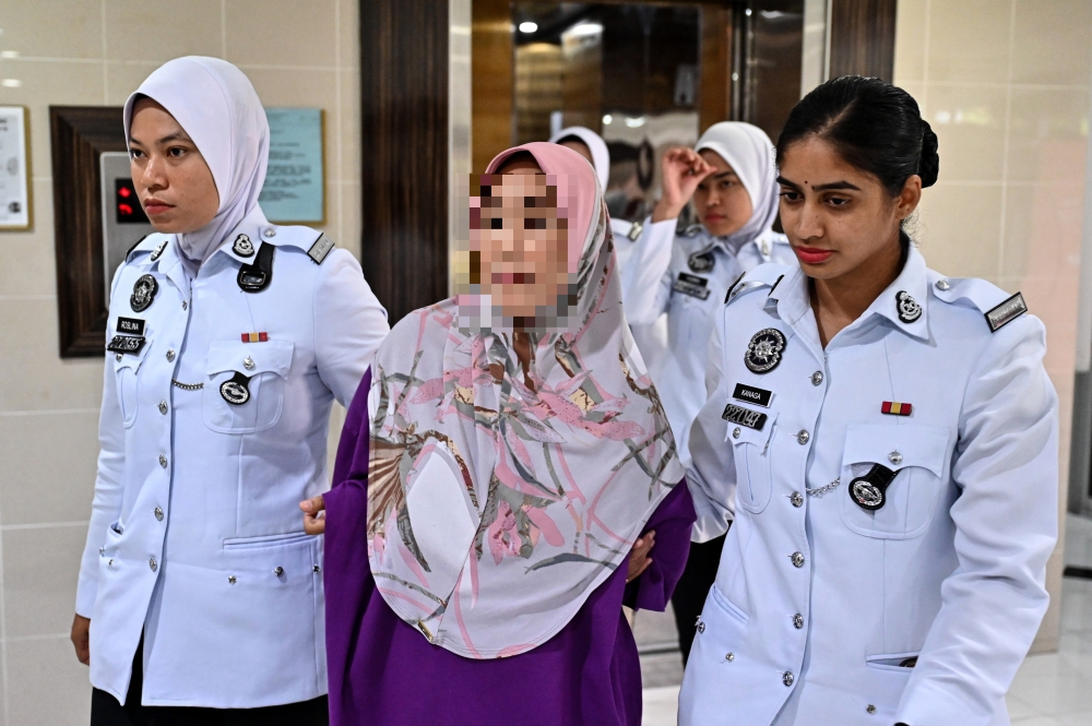A woman, whose car collided with two motorcycles, resulting in the deaths of three students from Universiti Teknologi Mara (UiTM) Dungun last night, is brought to the Kuala Terengganu Court Complex October 10, 2024, for her remand hearing. — Bernama pic