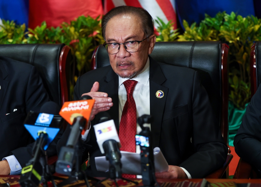 Prime Minister Datuk Seri Anwar Ibrahim speaks during a press conference when attending the 44th and 45th Asean Summit and Related Conferences in Vientiane October 11, 2024. — Bernama pic