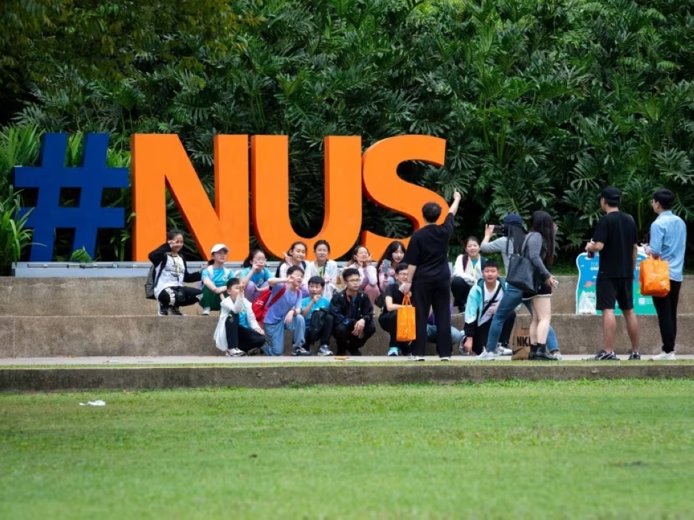 Tourists taking photos at the National University of Singapore on January 31, 2024. — TODAY pic