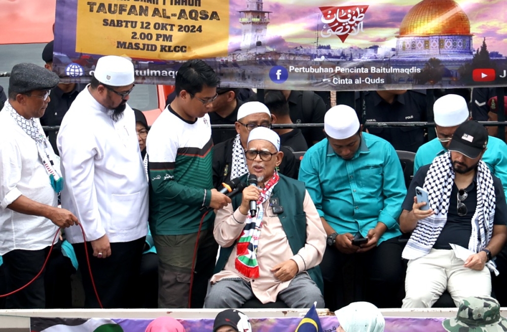 PAS President Tan Sri Hadi Awang (fourth from left) speak to the pro-Palestinian demonstrators on a makeshift stage outside the US Embassy on Jalan Tun Razak on October 12, 2024. — Picture by Firdaus Latif