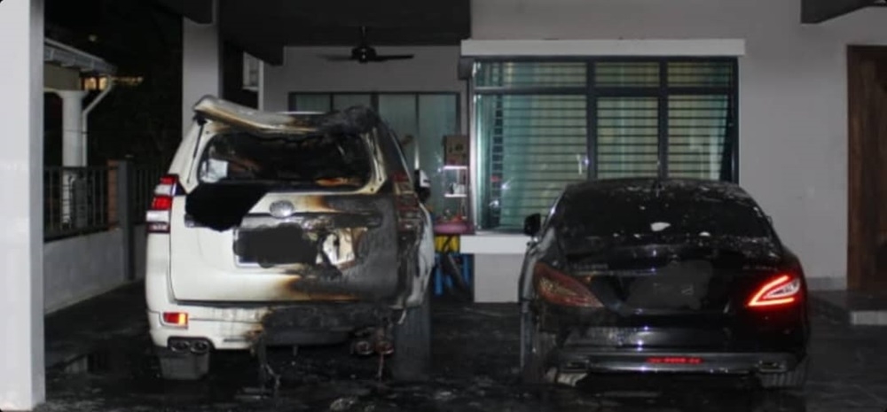 A handout photo shows the two damaged vehicles following the Molotov cocktail attack. — Picture courtesy of police