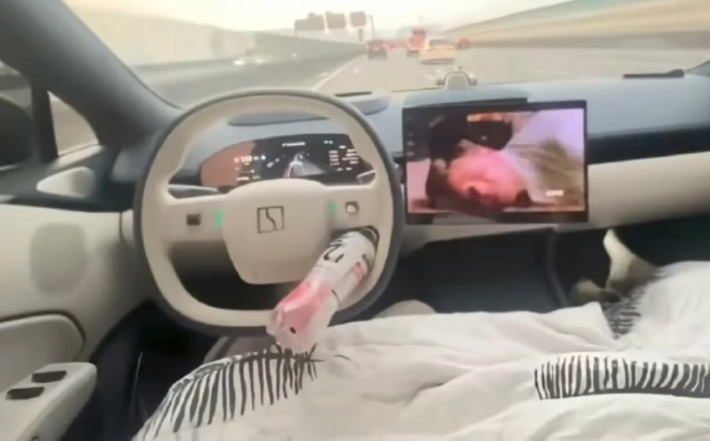 A screengrab from Weibo of a video allegedly showing how the driver jammed a plastic bottle into the steering wheel to trick the self-drive system. 