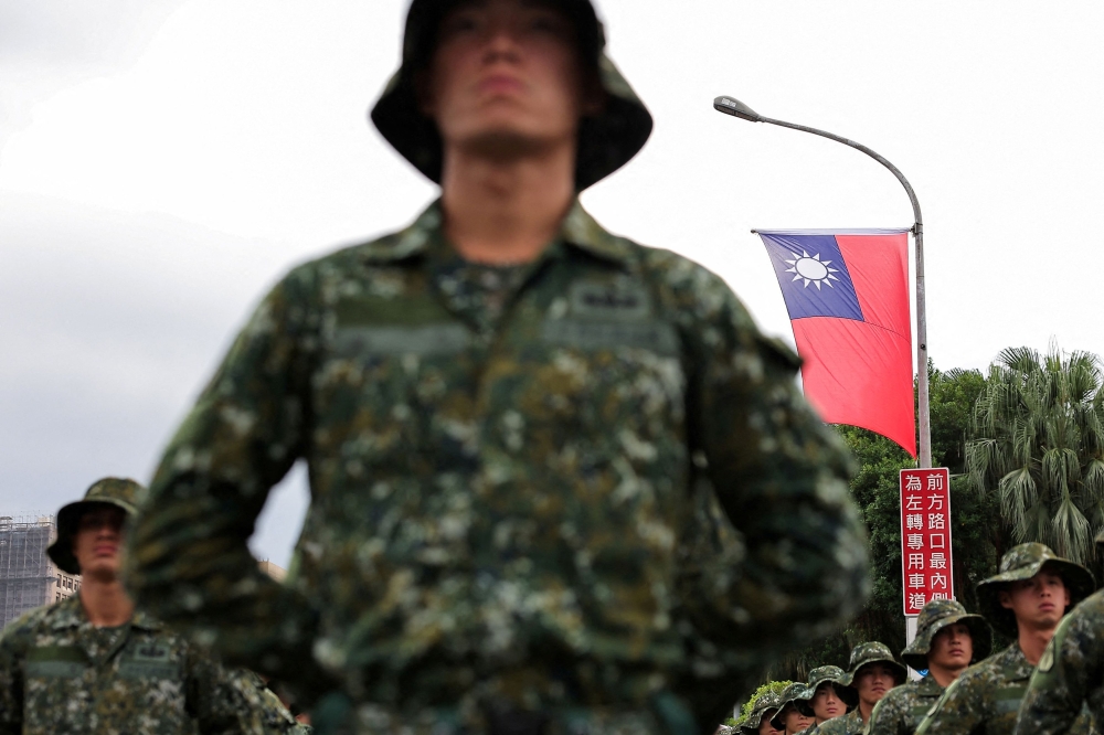 A Taiwan flag flutters in the wind as soldiers prepare to celebrate national day to mark the 113th birthday of the Republic of China, Taiwan’s formal name, in Taipei, Taiwan October 10, 2024. — Reuters pic