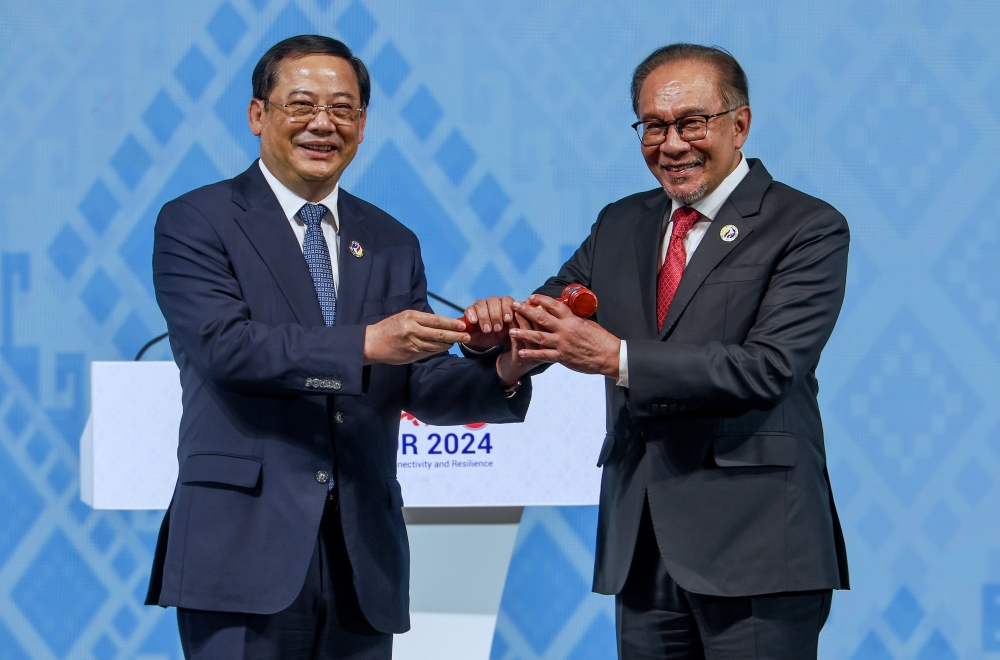 Prime Minister Datuk Seri Anwar Ibrahim being handed over the gavel of Asean Chairmanship by Laos Prime Minister Sonexay Siphandone during the closing ceremony of the 44th and 45th Asean Summits and Related Summits at the National Convention Centre in Vientiane October 11, 2024. Malaysia symbolically received the Asean Chairmanship from Laos today, signifying the beginning of its term as Asean Chair, effective January 1, 2025. — Bernama pic 