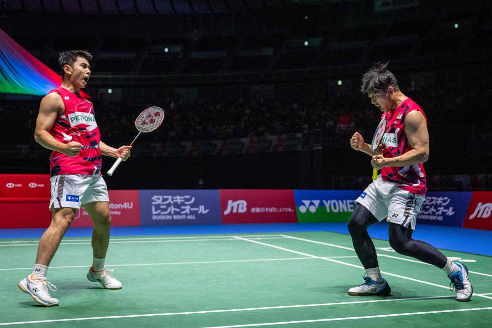 A file photograph shows Goh Sze Fei and Nur Izzuddin (right) celebrating a victory in Yokohama, Kanagawa prefecture, south of Tokyo on August 24, 2024. — AFP pic
