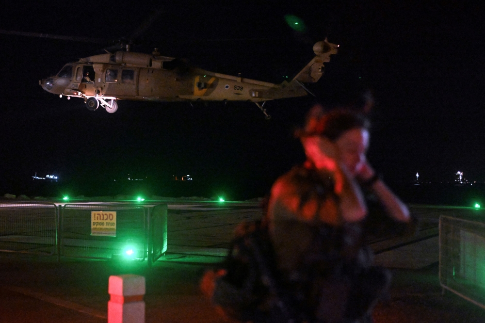 An Israeli soldier stands by as a military helicopter takes off after it dropped off patients that were injured in a drone attack from Lebanon, amid cross-border hostilities between Hezbollah and Israel, at Rambam Health Care Campus in Haifa, Israel, October 13, 2024. — Reuters pic