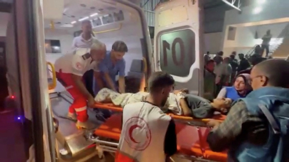 Members of the Palestine Red Crescent Society assist a Palestinian person on a stretcher, during the evacuation of people from Kamal Adwan Hospital in northern Gaza to Al-Shifa Hospital in Gaza City, at Al-Shifa Hospital in Gaza City October 12, 2024. — Reuters pic