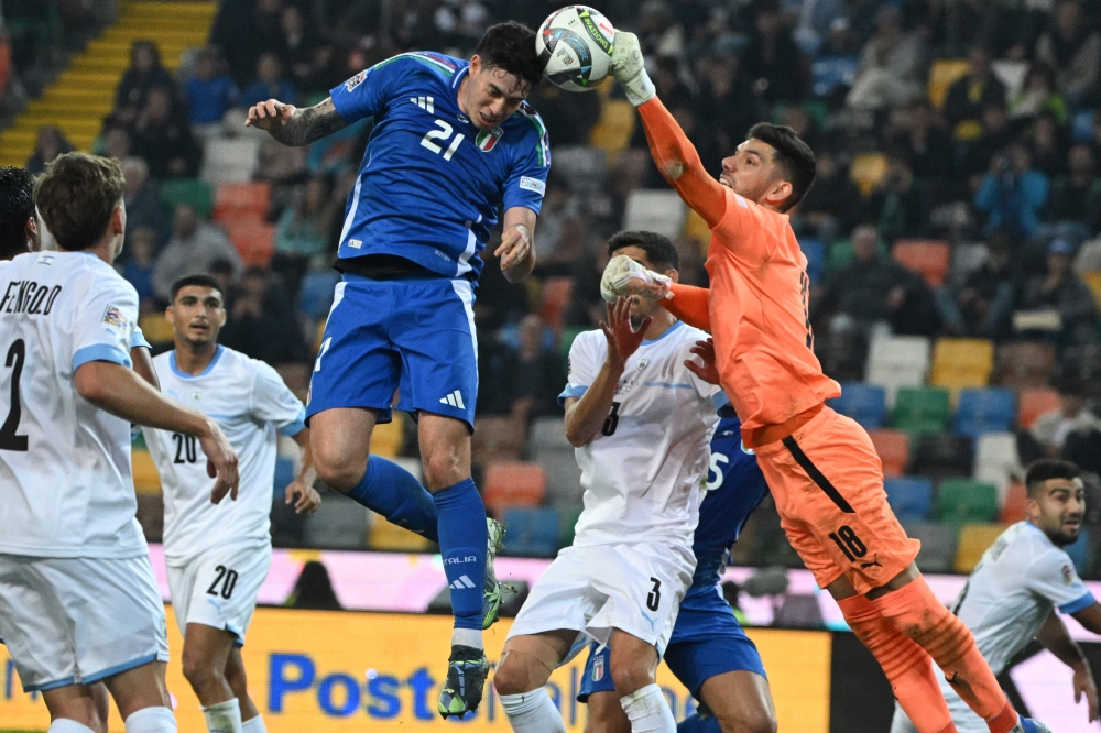 Italy's #21 Alessandro Bastoni heads the ball during the UEFA Nations League match against Israel at the Friuli Stadium in Udine. — AFP pic
