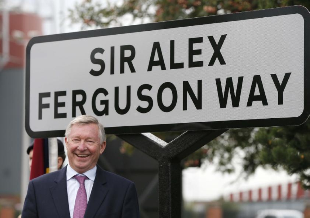 A file photograph showing former Manchester United manager, Alex Ferguson, posing next to the newly named ‘Sir Alex Ferguson Way’ in Manchester, northern England on October 14, 2013. — Reuters pic