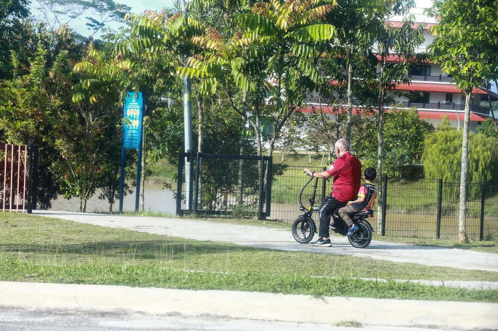 File photo of a man riding an electric bicycle in Sakura Lake Park in Elmina, Selangor September 19, 2024. — Picture by Sayuti Zainudin