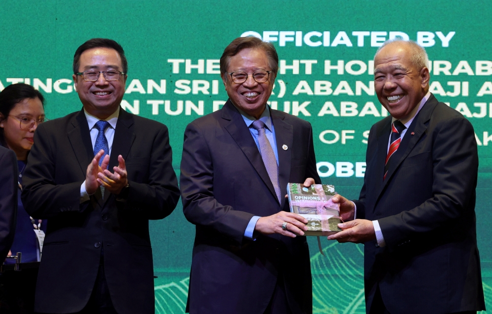Sarawak Premier Tan Sri Abang Johari Tun Openg receives a memento from Tropical Science Foundation Chairman Tan Sri Ahmad Tajuddin Ali during a dinner event in conjunction with the International Conference on Tropical Sciences 2024 in Kuching October 16, 2024. — Bernama pic