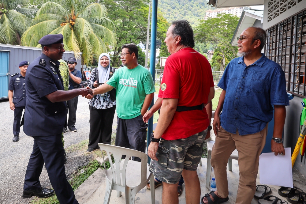 Selangor Police Chief Datuk Hussein Omar Khan meets residents of Jalan E6, Taman Melawati at a temporary shelter in Kuala Lumpur October 17, 2024. — Bernama pic