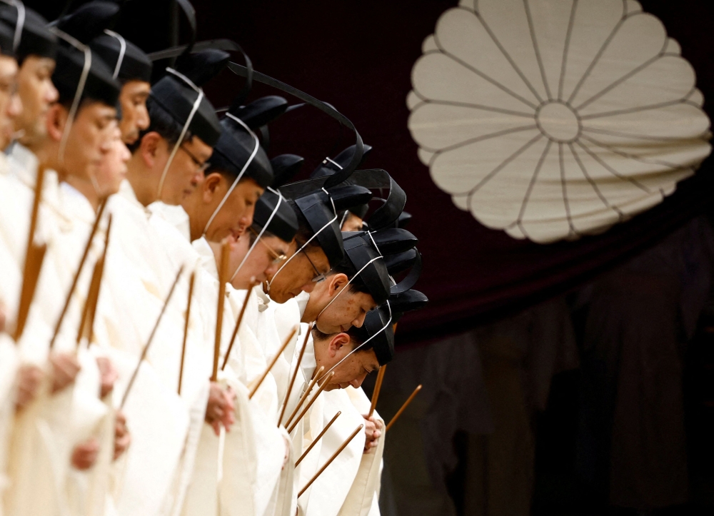Japanese Shinto priests bow as they attend a ritual during an autumn festival at Yasukuni Shrine in Tokyo, Japan, October 17, 2024. — Reuters pic