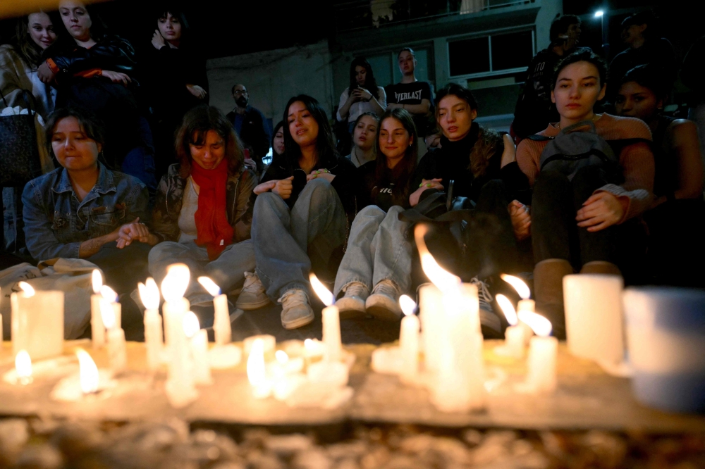 Fans of British singer Liam Payne lit candles next to the hotel where he died in Buenos Aires on October 16, 2024. British singer Liam Payne, former member of the group One Direction, died Wednesday aged 31 after falling from the third floor of a hotel in Argentina, police in Buenos Aires said. — AFP pic