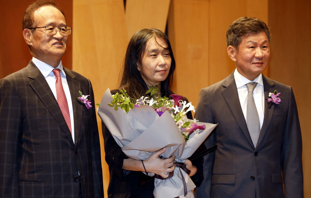 Novelist Han Kang, the first Korean to win the Nobel Prize in Literature, takes a group photo with Chung Mong-gyu, chairman of Pony Chung Foundation and Choo Sun-hoe, director of Pony Chung Foundation, at the 18th Pony Chung Innovation Award ceremony in Seoul, South Korea, October 17, 2024. — Reuters pic