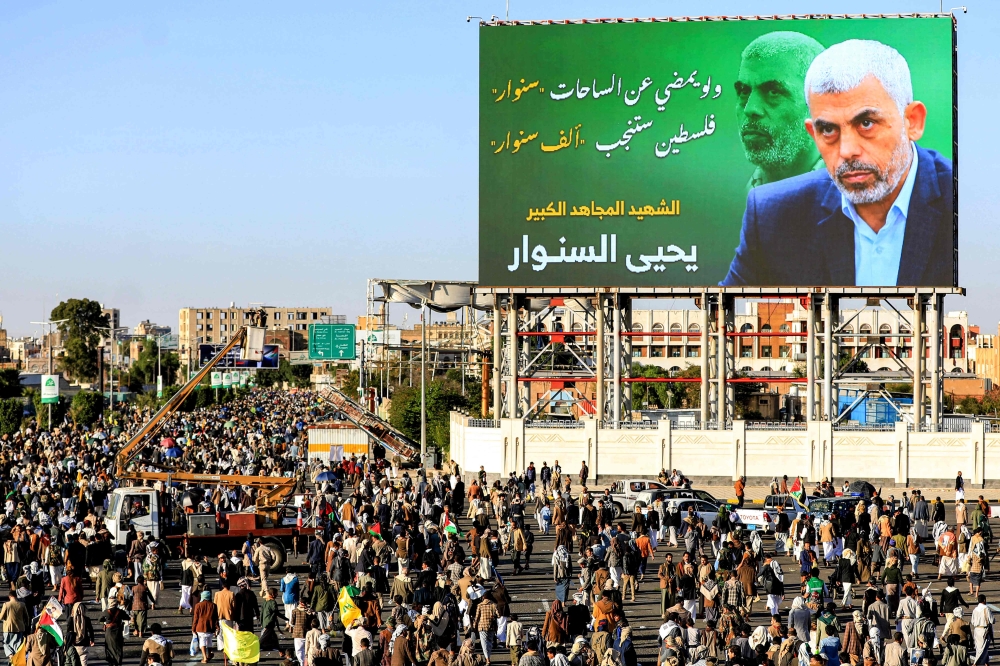 A billboard depicting Hamas’ slain leader Yahya Sinwar with the Arabic slogan “if Sinwar departs from the battlefields, Palestine will birth a thousand Sinwars”, during a rally in Yemen’s Huthi-controlled capital Sanaa on October 18, 2024. — AFP pic 