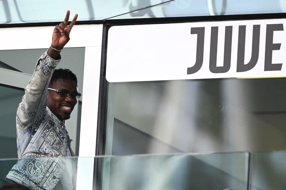 French forward Paul Pogba waves as he arrives to attend the Italian Serie A football match between Juventus and Cagliari at the Allianz stadium in Turin, on October 6. — AFP