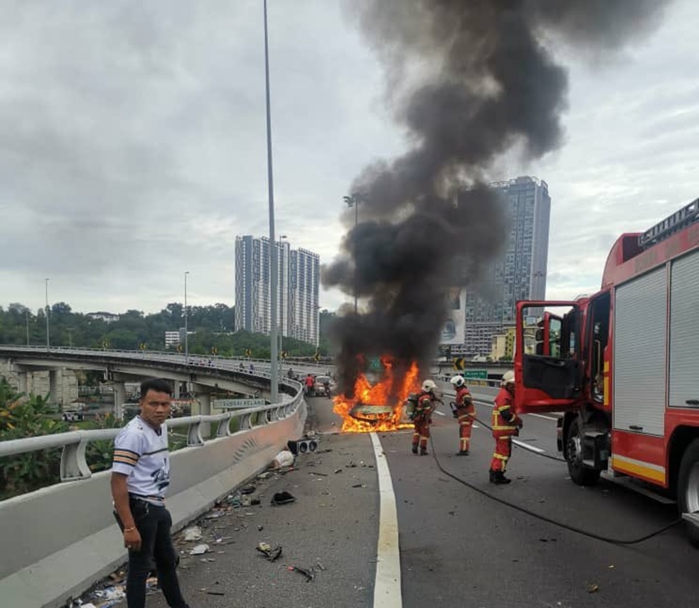 A driver was killed while his passenger suffered minor injuries after the car they were in skidded and burned in an accident on KM14.9 of the New Pantai Expressway at about 8am today. — Picture courtesy of the Fire and Rescue Department