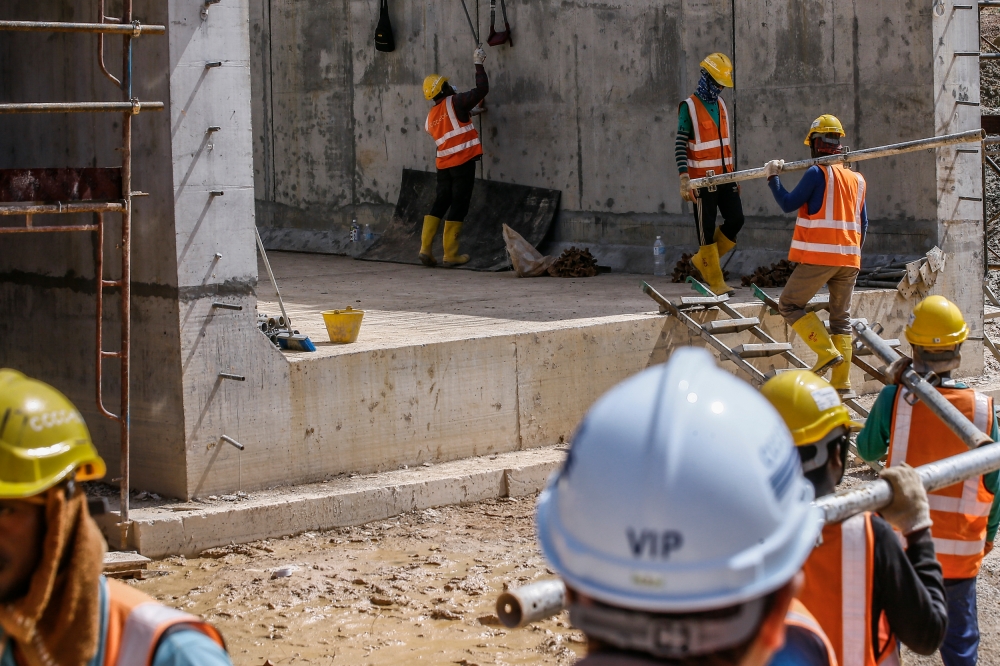 Construction workers for the East Coast Rail Link (ECRL) project are seen working on the Wildlife Box Crossing section at the Kemasul forest reserve in Pahang March 6, 2023. — Picture by Hari Anggara