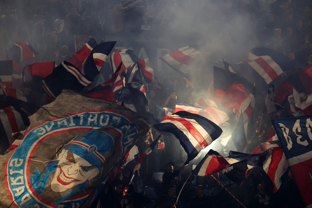 Paris' supporters wave flags before the French L1 football match between Paris Saint-Germain (PSG) and RC Strasbourg Alsace at the Parc des Princes Stadium in Paris on October 19, 2024. — AFP pic