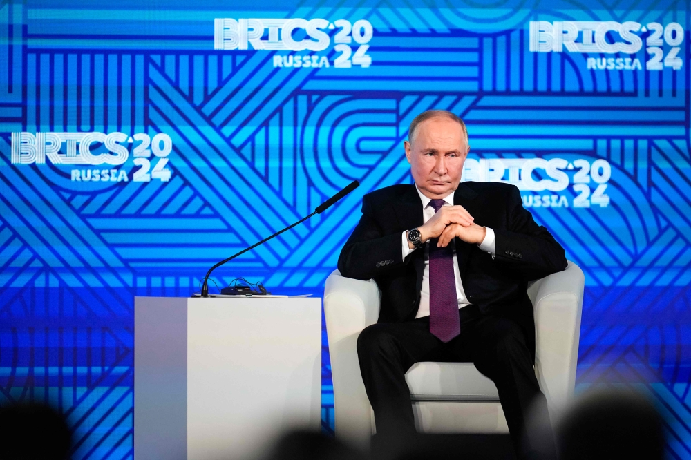 Russian President Vladimir Putin attends a BRICS business forum in Moscow on October 18, 2024. — AFP pic