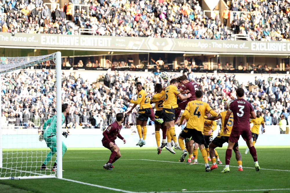 Manchester City's John Stones scores the team's second goal during the English Premier League football match between Wolverhampton Wanderers and Manchester City at the Molineux stadium in Wolverhampton, central England on October 20, 2024. — AFP pic