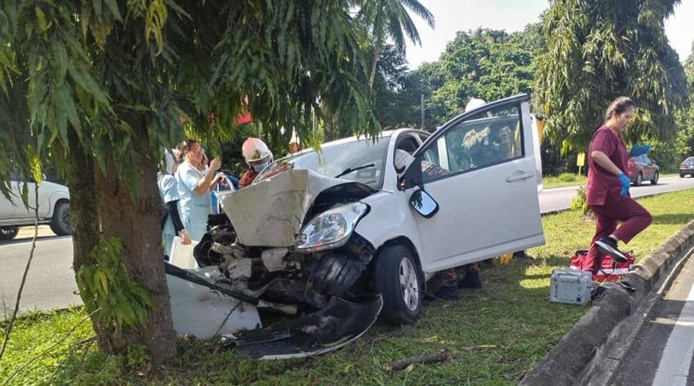 Firefighters extricating the victim, who was pinned to the driver’s seat. — Picture courtesy of the Fire and Rescue Department