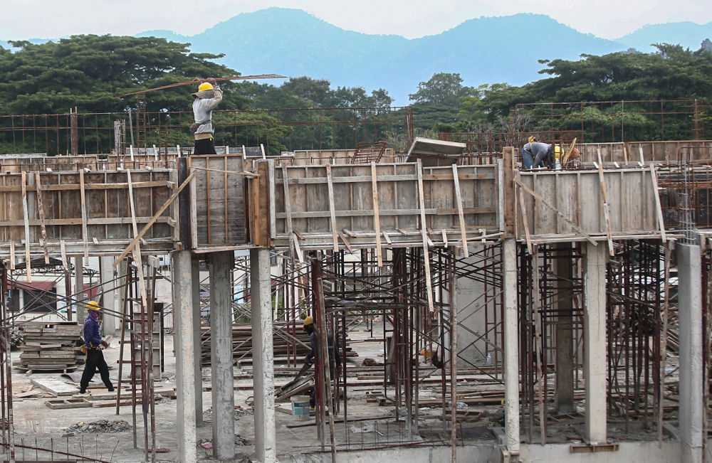 File picture of construction workers working at a site in Ipoh August 3, 2023. The Ministry of Housing and Local Government said the target for the construction of 500,000 affordable homes has reached 89 per cent, with 443,259 units completed, under construction, and planned across the country as of September. — Picture by Farhan Najib