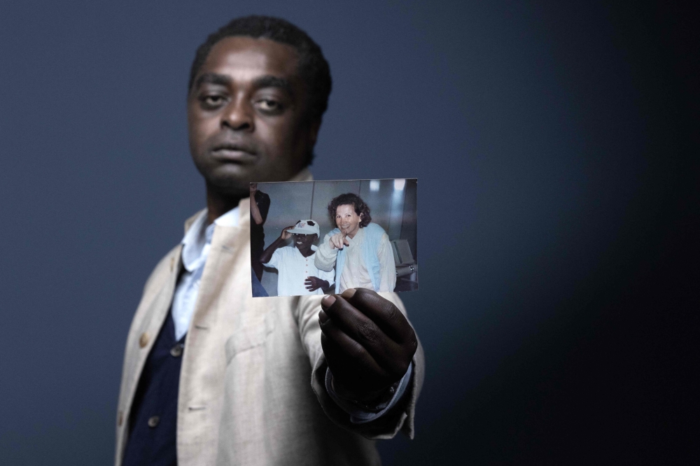 Rwandan-born French Gaspard Jassef shows a photograph depicting him with his adoptive mother Dominique Jassef taken on June 21, 1995, upon his arrival at a French airport after his adoption, during a photo session in Paris, on June 5, 2024. Gaspard Jassef lost his mother and sister when he was a child during the genocide that affected the Tutsi minority in Rwanda in 1994. He also lost his father and was orphaned in Rwanda. He was adopted in 1995 in France, where he has been trying to rebuild his life for the past 30 years. — AFP pic 