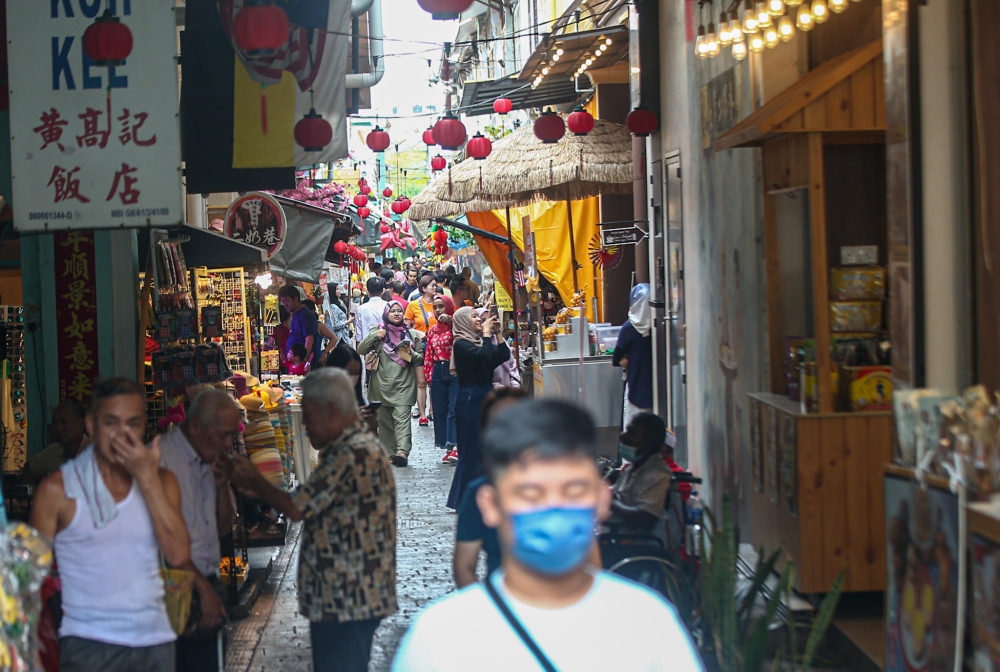 File photo of tourists visiting Concubine Lane in Ipoh. The cause of tremors and a loud bang that shook Ipoh at 11:06am yesterday remains a mystery. — Picture by Farhan Najib