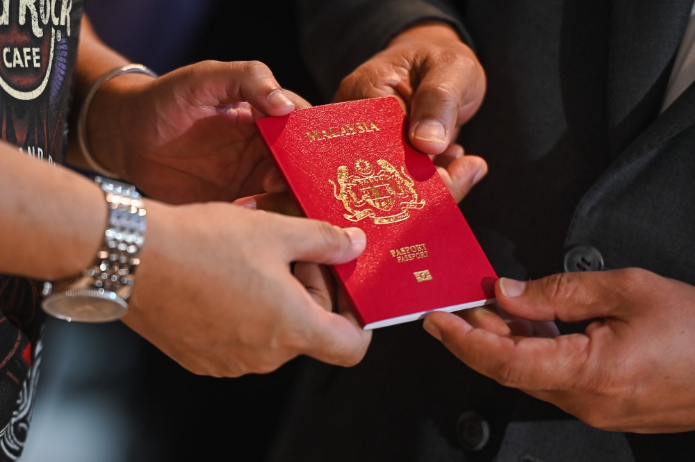 A file photograph shows a Malaysian passport being displayed at the Immigration Department office in Putrajaya on February 19, 2024. — Picture by Miera Zulyana