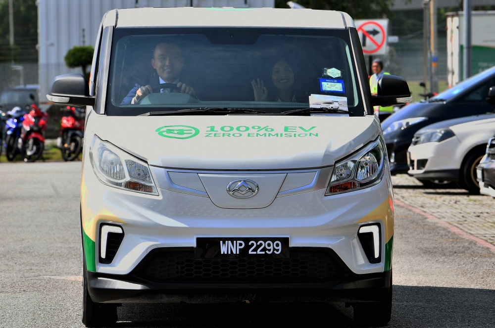 Deputy Communications Minister Teo Nie Ching with City-Link Express CEO Ronald Tan (left) riding City-Link’s first electric vehicle at the ‘A Sustainable Greener Last Mile Delivery’ event held at the City-Link Super Hub in Bandar Saujana Putra, October 23, 2024. — Bernama pic   